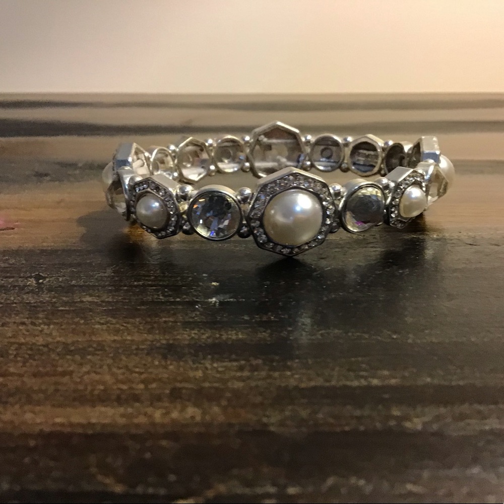 It is a bracelet it is Silver with pearls on it